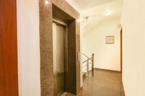 a hallway with a door in a building at FabHotel Silver Oak BnB - Nr Yashobhoomi Convention Centre in Jāmb