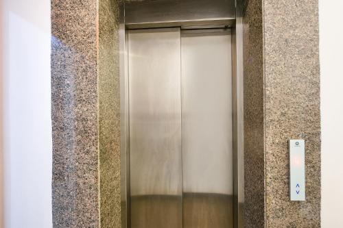 a elevator in a building with a wall at FabHotel Silver Oak BnB - Nr Yashobhoomi Convention Centre in Jāmb
