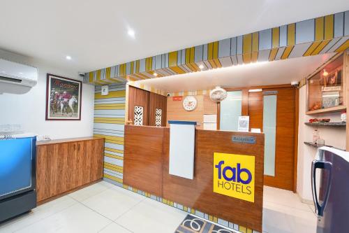 a restaurant lobby with a ibid huts sign on the wall at FabHotel Silver Oak BnB - Nr Yashobhoomi Convention Centre in Jāmb