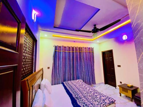 a bedroom with a bed and a purple ceiling at Moonlight Guest House in Rawalpindi
