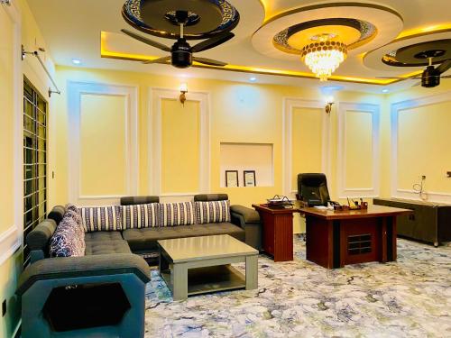 a living room with a couch and a table at Moonlight Guest House in Rawalpindi