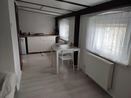kuchnia ze stołem i krzesłami w pokoju w obiekcie Apartament Mariacka w Bydgoszczy