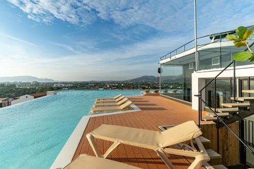 a swimming pool on the roof of a house at The Blue Mavi Hotel in Chalong 
