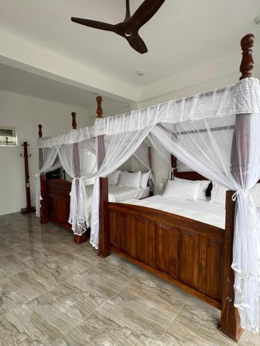 a bedroom with two beds and a ceiling fan at Tea Hills Lake in Hatton
