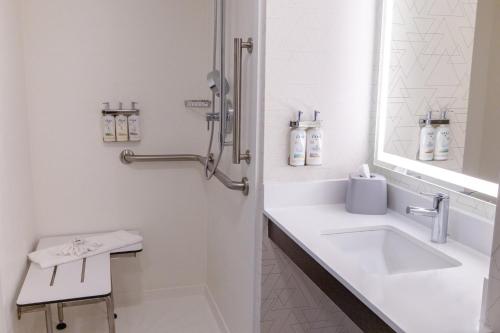 a white bathroom with a sink and a mirror at Holiday Inn Express - Neptune by IHG in Neptune City