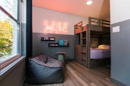 a bedroom with a bunk bed and a window at voco The Darwin - Atlanta Midtown by IHG in Atlanta