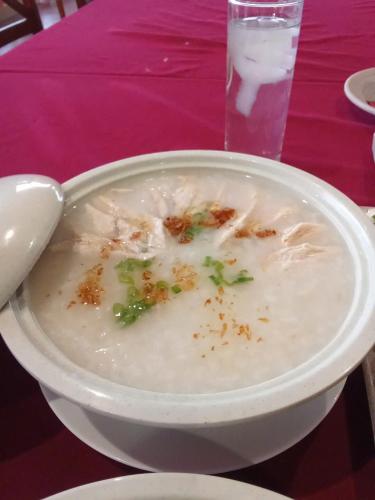 a bowl of soup with a spoon on a table at Texas Corner Garden Resort in Xóm Tram