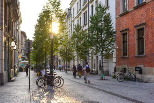 a cobblestone street with people walking down the street at MedHotel Smart Krupnicza w Krakowie in Kraków