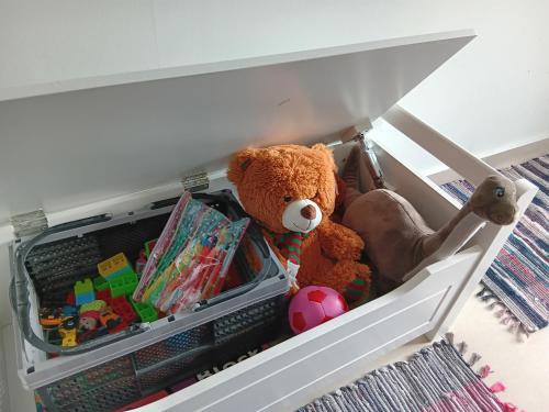a stuffed teddy bear and other toys in a drawer at Elato apartment in Florina
