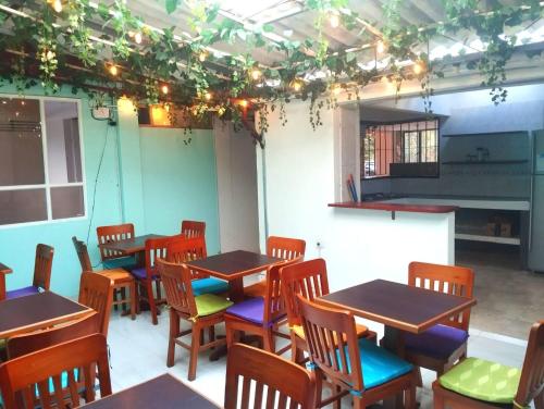 a room with tables and chairs and a piano at Serene Oasis in Pasto Cozy Guest Room with Private Bathroom in Pasto