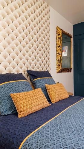 a bedroom with a large bed with a large headboard at La Carte Postale in Oye-Plage