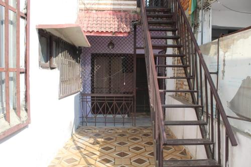 a stairway leading into a building with a door at Mother's Homestay in Lucknow
