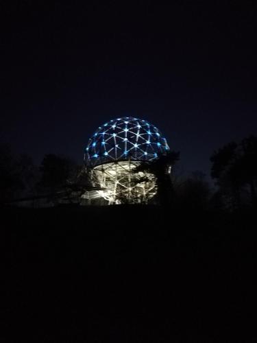 a night view of a lit up disco ball at Sailor Apartman Balatonlelle in Balatonlelle
