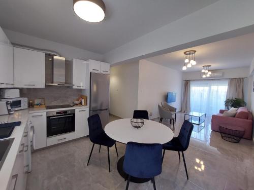 a kitchen and living room with a table and chairs at Hawaii Holiday Apartment 41 in Limassol