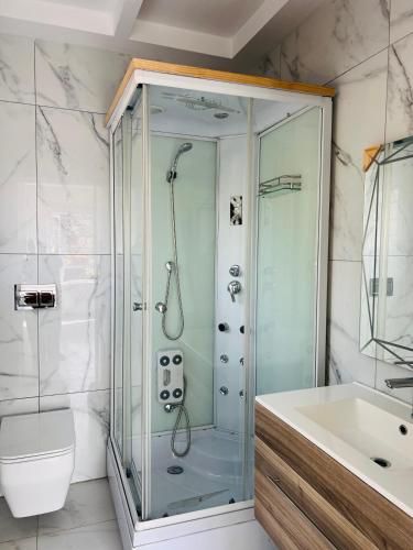 a bathroom with a shower and a sink at Villa Le Rosa Unit 5 in Durban