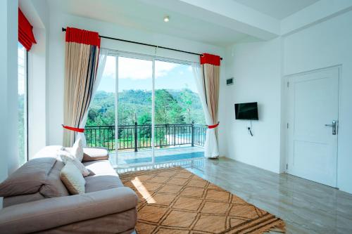 a living room with a couch and a large window at Tea Hills Lake in Hatton