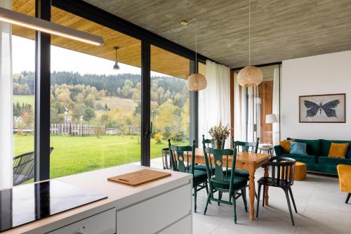 a kitchen and dining room with a table and chairs at Proste Chwile in Tylicz
