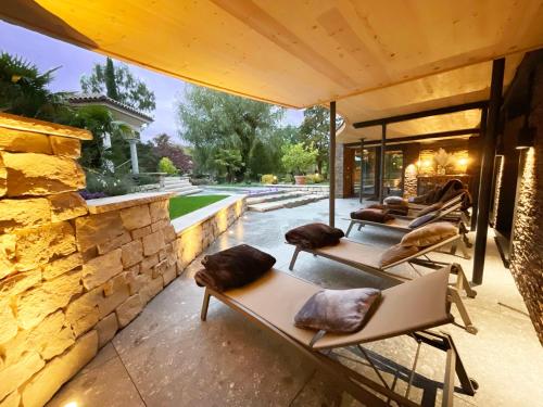 a row of chaise lounge chairs on a patio at Hotel Rebstock Durbach in Durbach