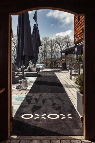 a rug with a bike on it in a patio with umbrellas at Gmundnerberghaus - ROOMS in Altmünster