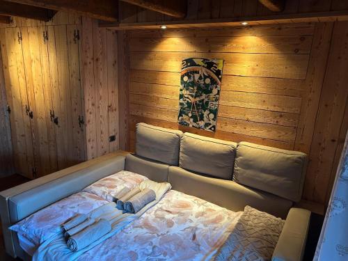 a room with a bed in a wooden room at Chalet sulle piste da sci con Garage a Limone 1400 in Limone Piemonte