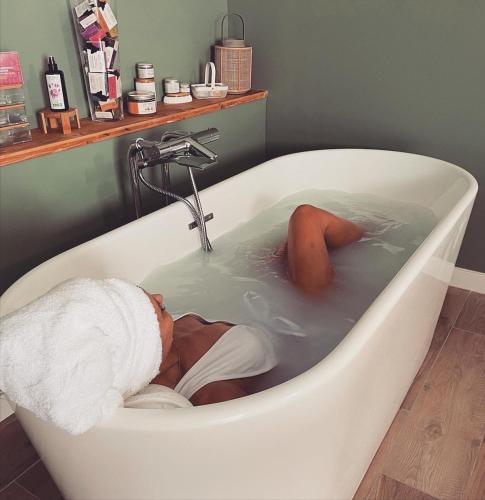 a baby is laying in a bath tub at Hitton Séjours Nature in Biran