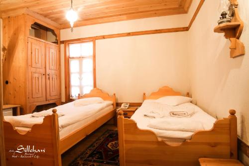 two beds in a small room with a window at Sillehan Boutique Hotel in Konya