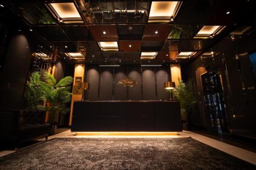 a lobby with a stage and plants in a building at Mandarin Club House in Batumi
