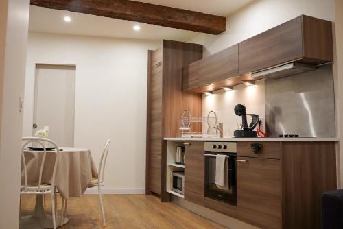 - une cuisine avec une cuisinière et une table dans une chambre dans l'établissement T2 cosy au cœur de Perpignan, à Perpignan