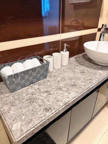 a bathroom with a sink and a counter with a sink at Wonderful 1BD With Full Marina View in Dubai