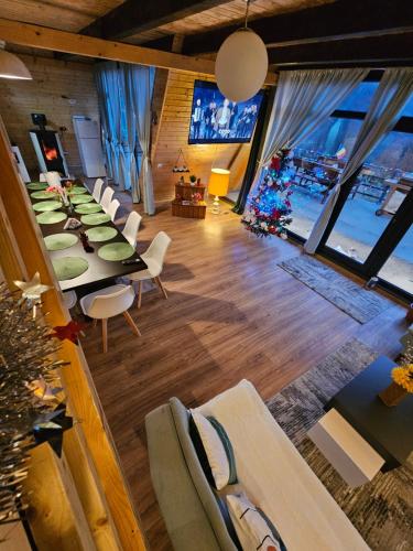 a dining room with a long table and chairs at Cabana Apuseni Wild in Valea Lupşei