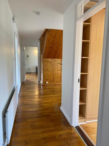 a hallway with wood floors and shelves in a house at Daline House Clonakilty in Clonakilty
