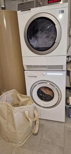 two washing machines and a bag on the floor at Casa Biala Dimora - Ski IN/OUT in Vigens