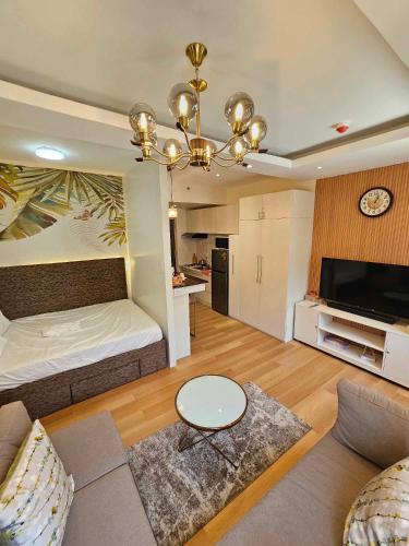 a large living room with a bed and a table at B&C Staycation by SMDC Cheer Residence in Lias