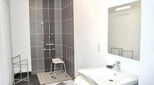 a bathroom with a shower with a sink and a mirror at Grande maison accueillante à Saint-Épain avec salle de réception in Saint-Épain