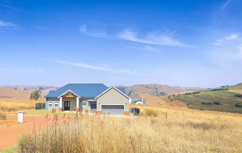 a house in the middle of a field at Highland Peace Haven In Dullstroom in Dullstroom