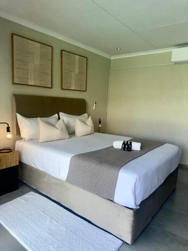 a bedroom with a large bed with white sheets at SUumthing Private GuestHouse in Lebowakgomo