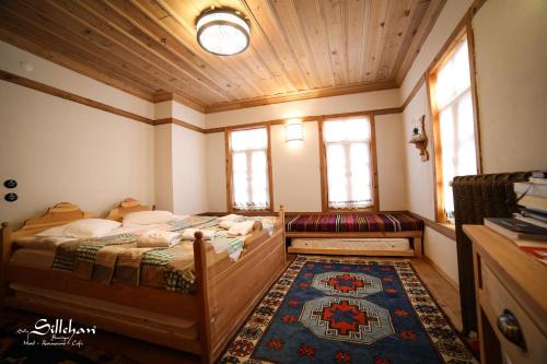 a bedroom with a bed and a couch and windows at Sillehan Boutique Hotel in Konya