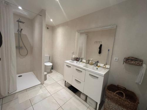 a white bathroom with a sink and a toilet at Villa de charme en Pays Catalan in Le Tech