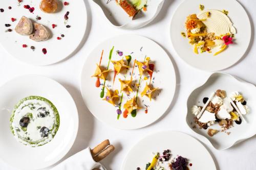 a group of plates of food on a table at Grand Hotel Courmayeur Mont Blanc, by R Collection Hotels in Courmayeur