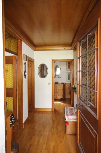 a hallway of a home with wooden floors and a door at Appartamento Croda with Large Panoramic Terrace and Private Garage in Cortina dʼAmpezzo