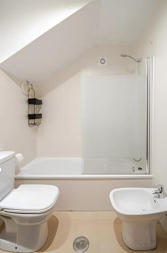 a white bathroom with a toilet and a sink at Great Apartment & Golf With Big Roof Terrace in Alhama de Murcia