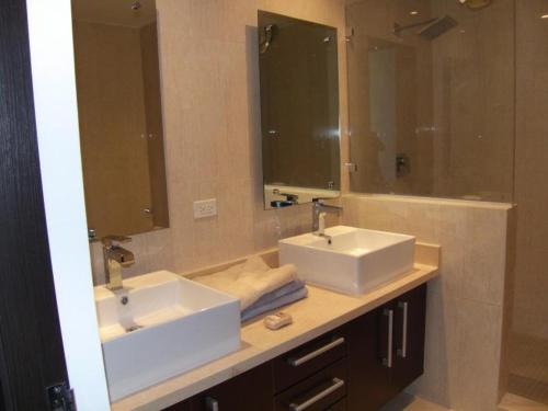 a bathroom with two sinks and a large mirror at Panoramic Ocean view Playa Blanca Suite in Playa Blanca