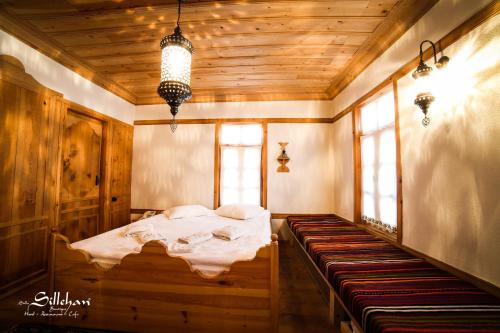 a bedroom with a bed in a room with windows at Sillehan Boutique Hotel in Konya