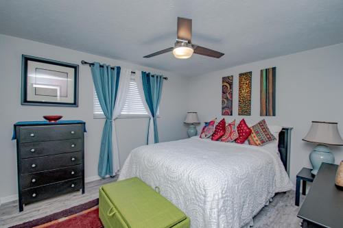 a bedroom with a bed and a ceiling fan at Lovely Eclectic Duplex - Peaceful Neighborhood in Trotwood
