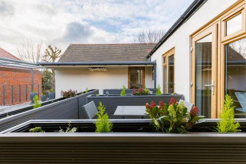 a garden on the roof of a house at Rosemay Hotel near London Heathrow Airport in Hayes