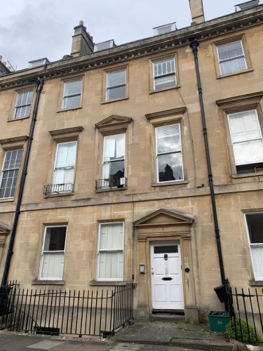 an old brick building with white doors and windows at The Paragon Penthouse - Stunning Views over Bath! in Bath