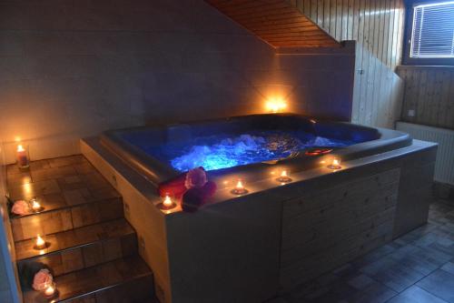 a bath tub with candles and lights in a bathroom at Restaurace a penzion Lutena in Dolní Lutyně