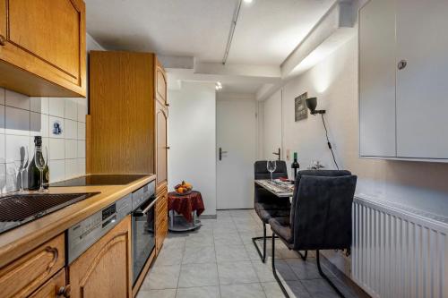 a kitchen with a table and a chair in it at Fewo Am Wiesbachtal in Wehrheim