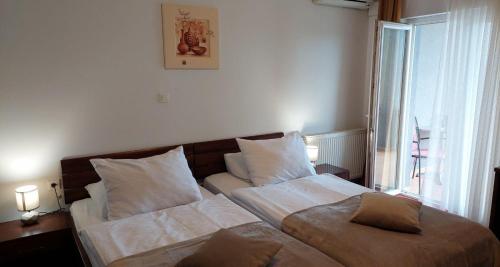 a bedroom with two beds and a window at Hotel Orion in Ivanec