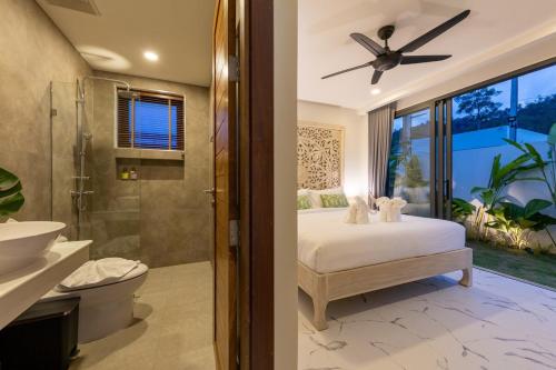 a bathroom with a bed and a shower and a toilet at Villa Gabriela Garden view - Included Airport pick up in Nathon Bay